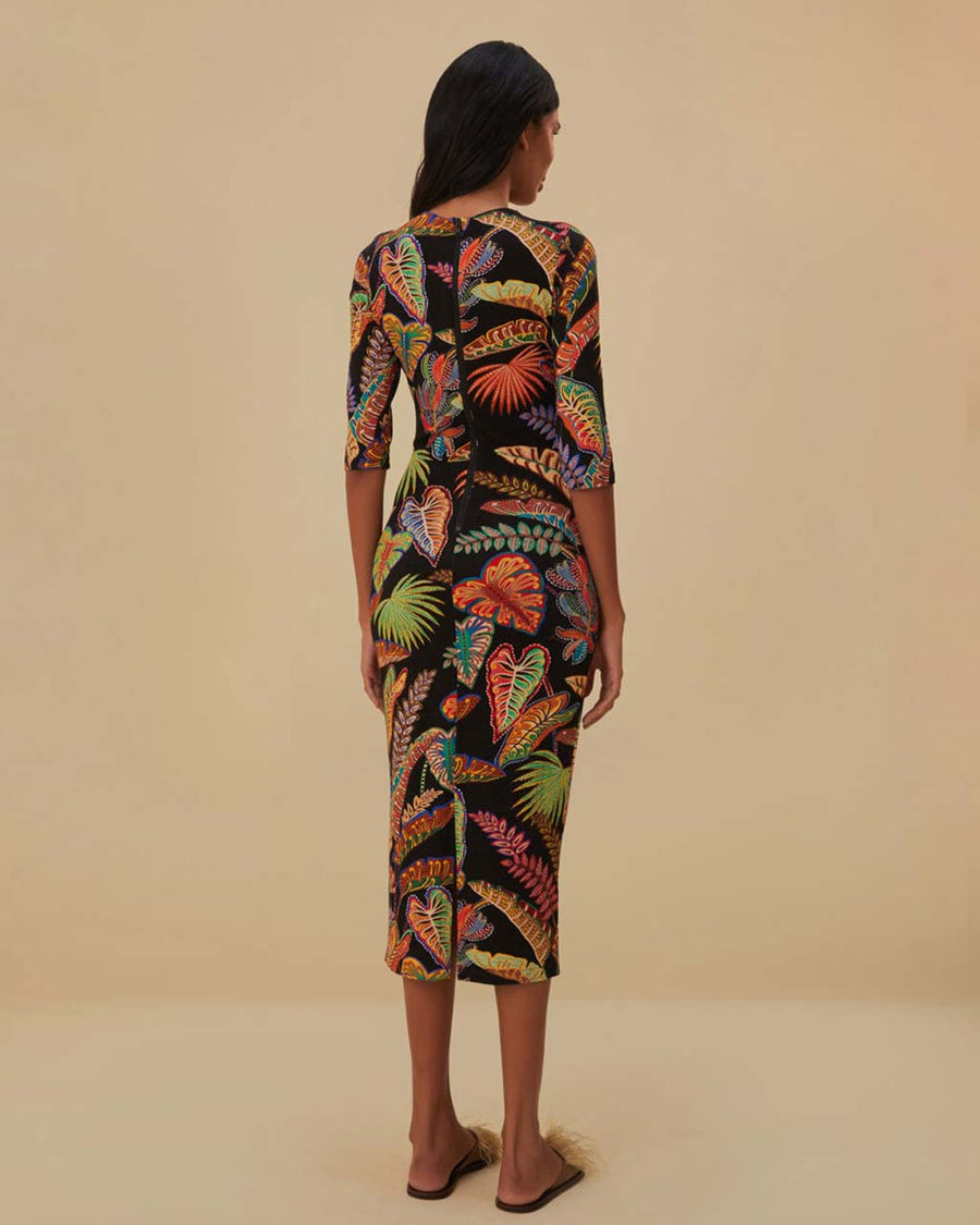 back view of model wearing black midi dress with quarter length sleeves and vibrant foliage print