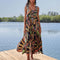 model wearing black maxi sundress with button front, low tie back and vibrant foliage print
