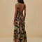 back view of model wearing black maxi sundress with button front, low tie back and vibrant foliage print