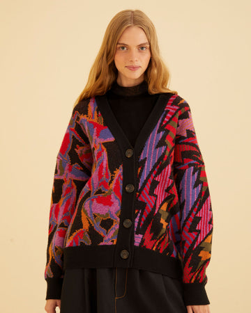 model wearing black cardigan with colorful horse print on one side and vibrant lightning bolt print on the other