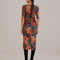 back view of model wearing colorful stitched floral bodycon midi dress with short sleeves