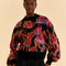 model wearing colorful wild horse sweater with beaded fringe detail
