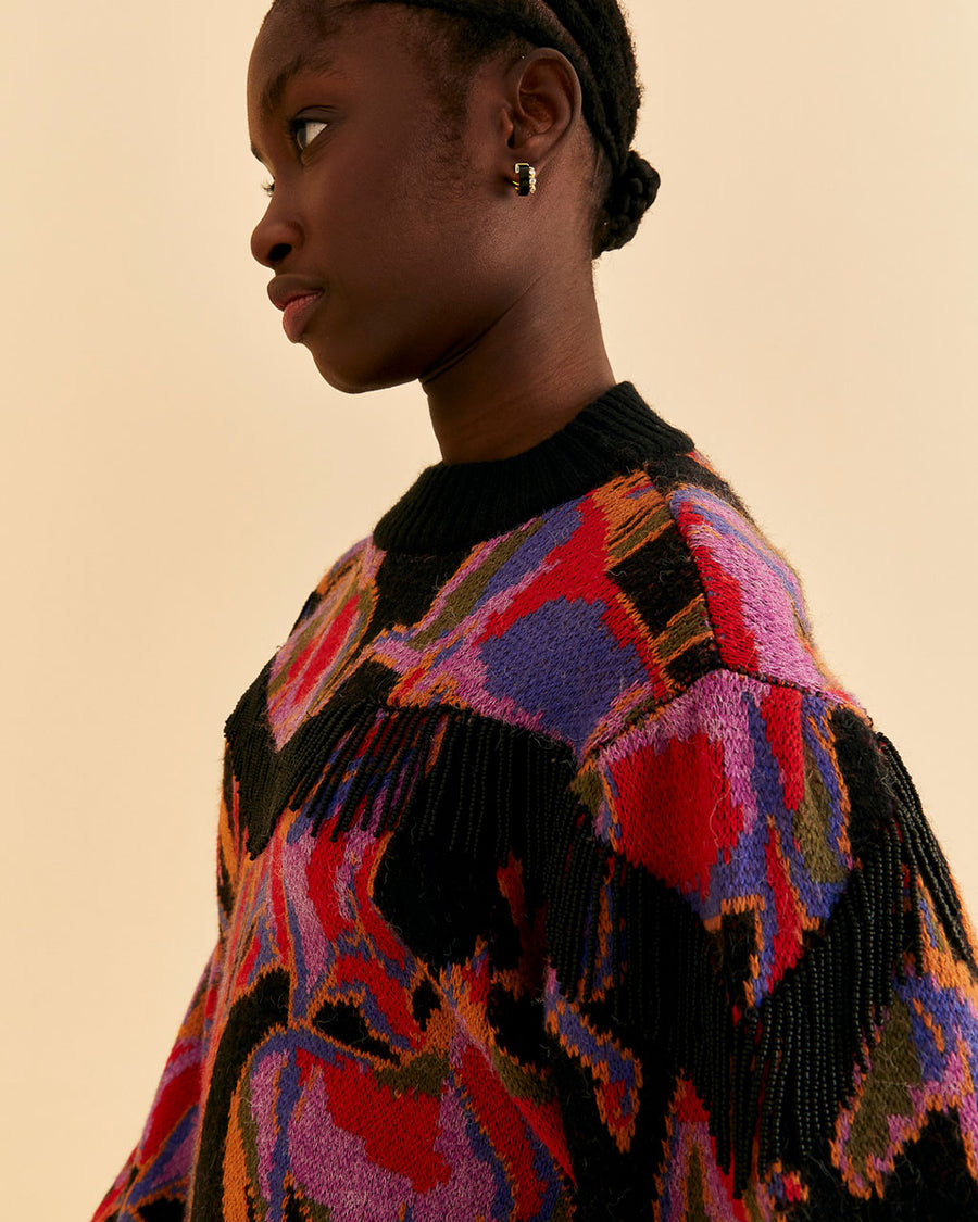 side view of model wearing colorful wild horse sweater with beaded fringe detail