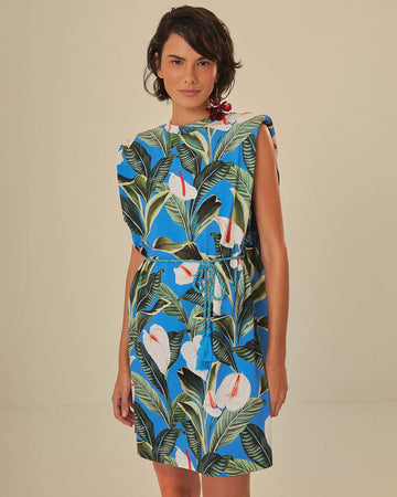 model wearing blue mini t-shirt dress with white anthurium flower print and tie waist
