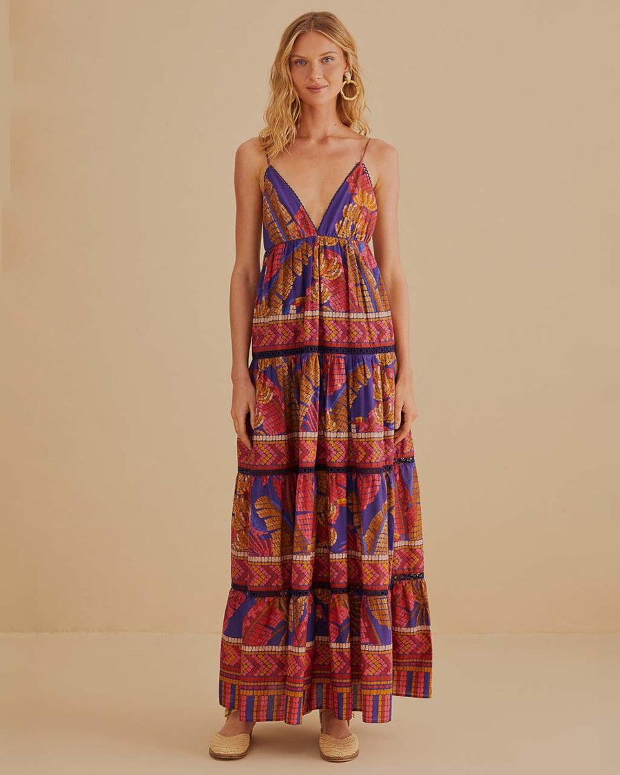 model wearing blue mosaic maxi dress with deep v neckline and pretty embroidered detail