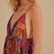 up close of model wearing blue mosaic maxi dress with deep v neckline and pretty embroidered detail