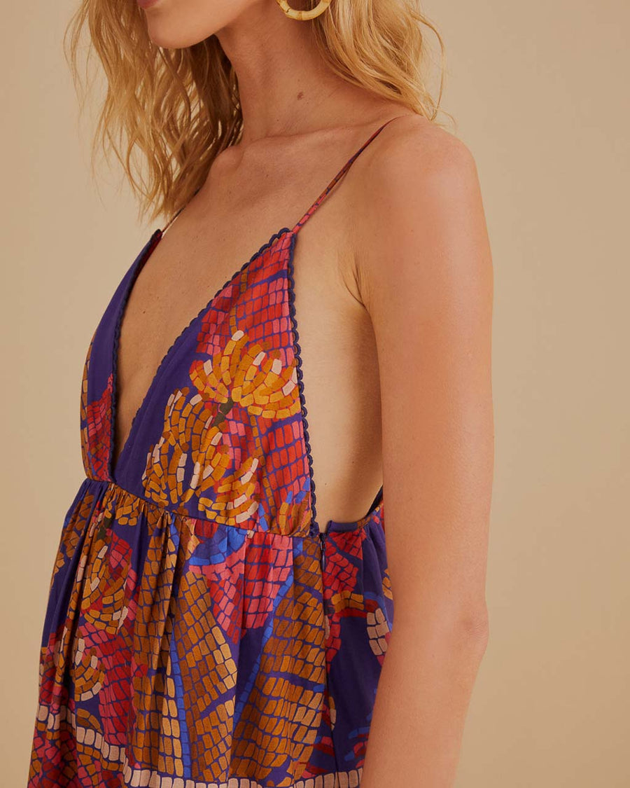 up close of model wearing blue mosaic maxi dress with deep v neckline and pretty embroidered detail