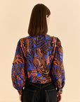 back view of button back on blue tropical print blouse