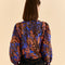 back view of button back on blue tropical print blouse
