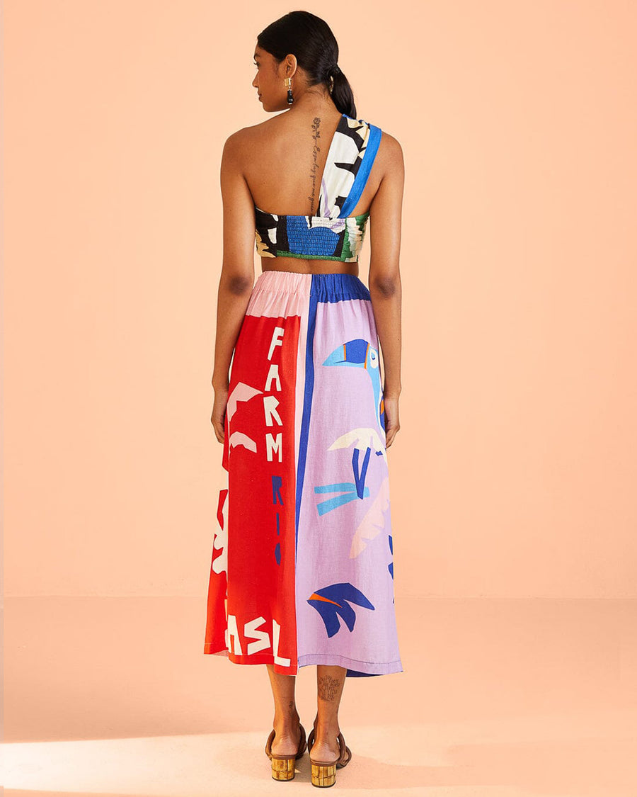 backview of model wearing colorful abstract print tie waist skirt