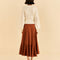 backview of model wearing caramel color ruffle maxi skirt and white cardigan