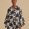 model wearing black and white palm tree print shorts and matching kimono top