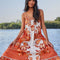 model wearing red, orange and white print maxi dress with ric rac detail and rope straps