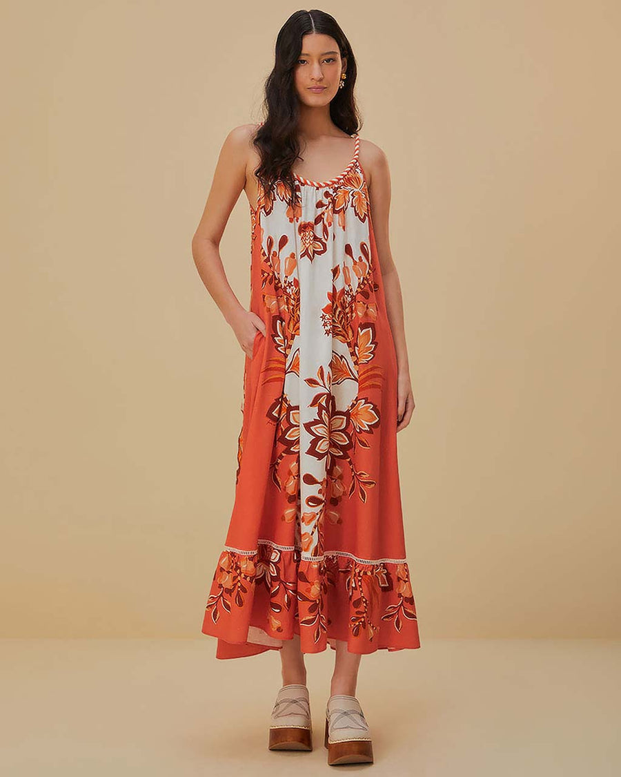 model wearing red, orange and white print maxi dress with ric rac detail and rope straps
