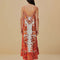 back view of model wearing red, orange and white print maxi dress with ric rac detail and rope straps