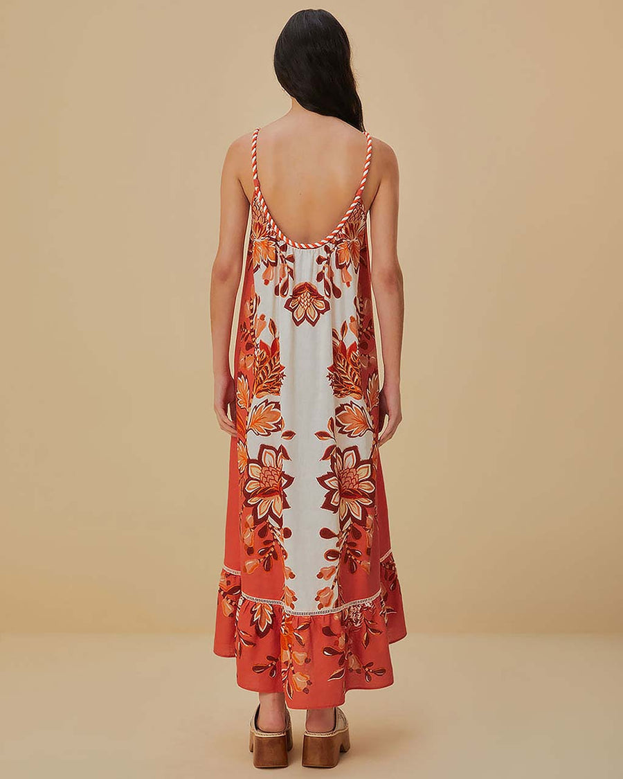 back view of model wearing red, orange and white print maxi dress with ric rac detail and rope straps