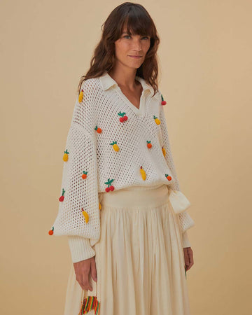 model wearing white open stitch top with 3D fruit,  collar, and v-neckline