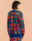 backview of navy blue patchwork cardi with mushroom, yin yang, swirls and patchwork designs