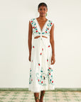 model wearing white midi dress with red floral embroidery, cut out waist and scalloped v neck