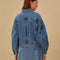 back view of model wearing slightly cropped light blue denim jacket