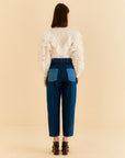 backview of model wearing relaxed leg denim with blue denim patchwork and button front