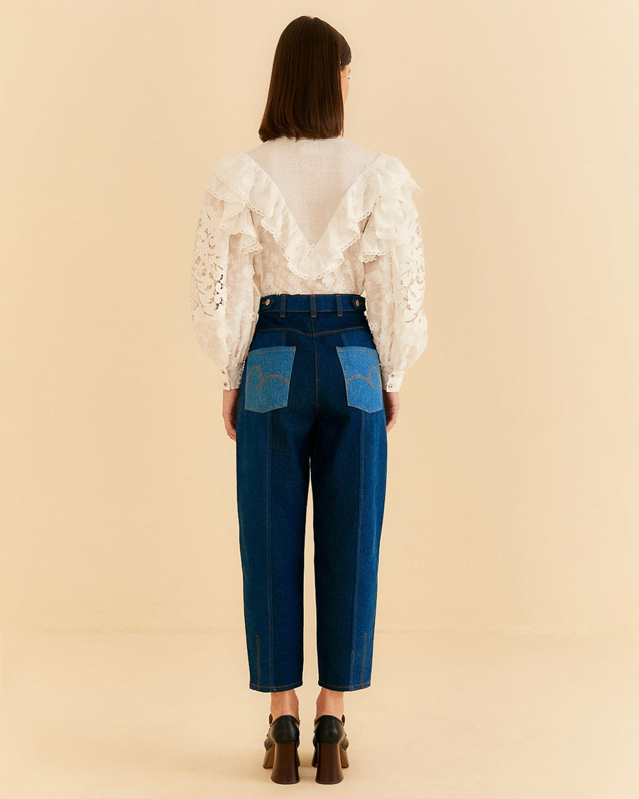 backview of model wearing relaxed leg denim with blue denim patchwork and button front