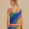 back view of model wearing open crochet cropped tank with diagonal rainbow stripes and matching skirt