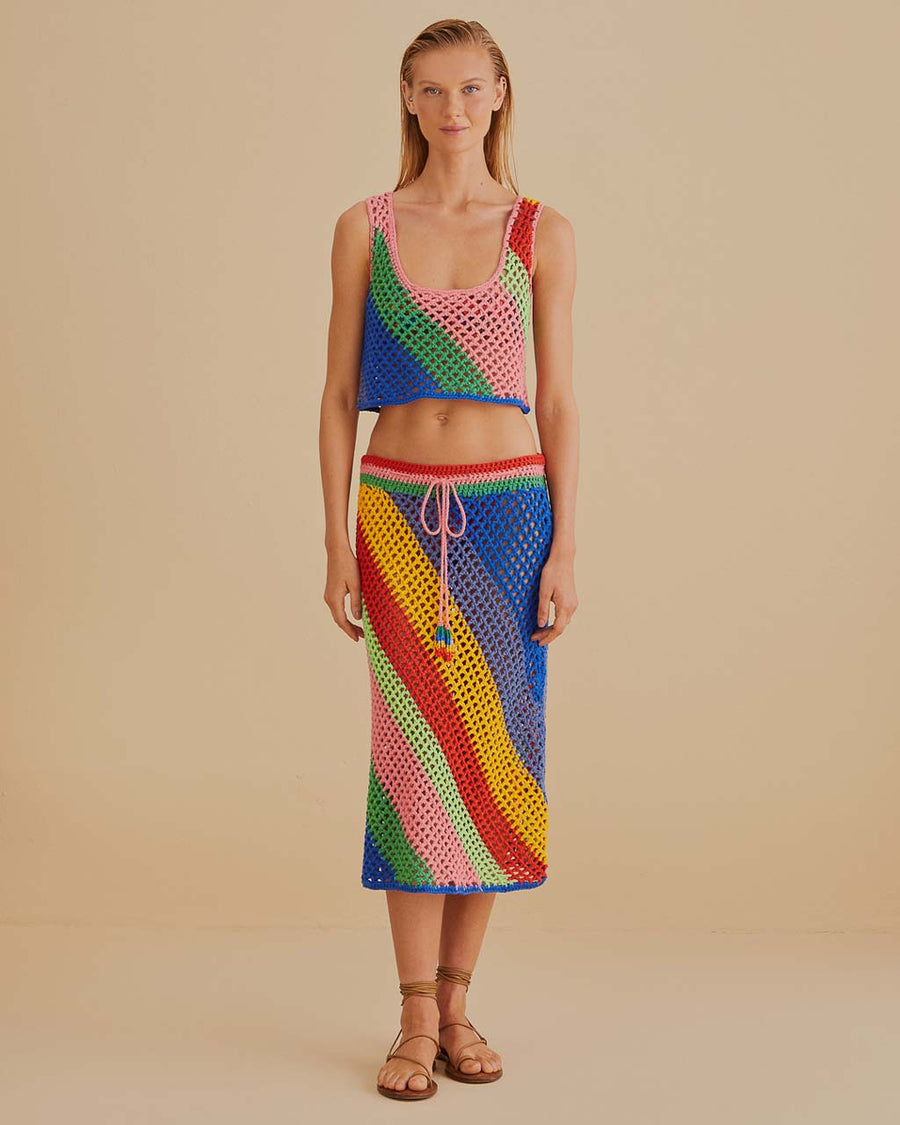 model wearing open crochet midi skirt with diagonal multicolor stripes and pink drawstring and matching cropped tank