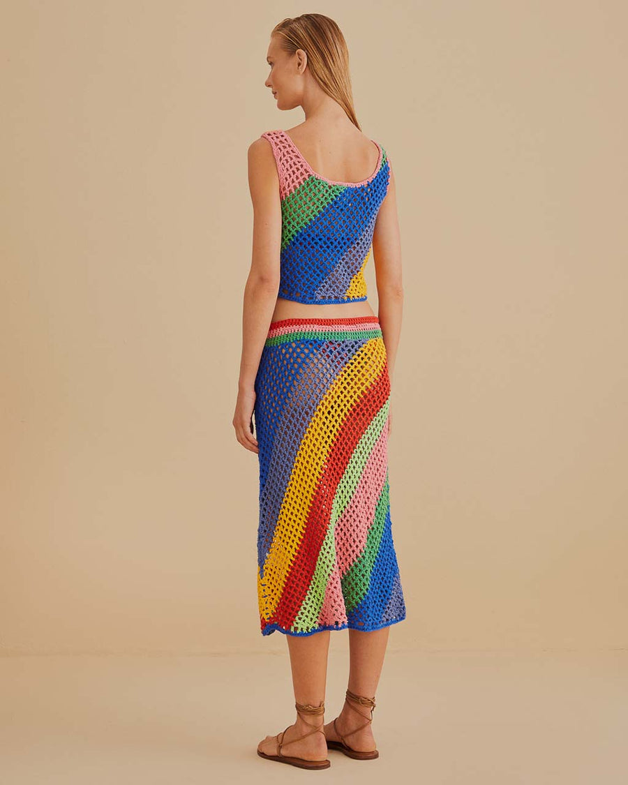 back view of model wearing open crochet midi skirt with diagonal multicolor stripes and pink drawstring and matching cropped tank