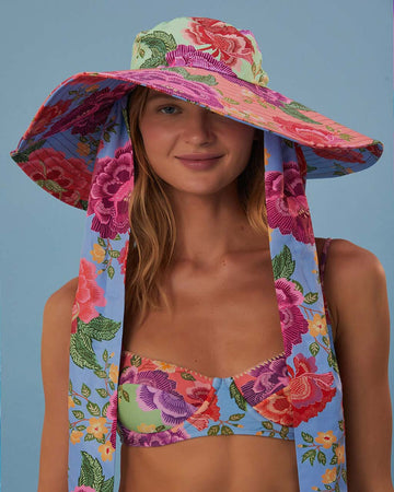 model wearing multi floral floppy hat with long straps