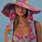 model wearing multi floral floppy hat with long straps
