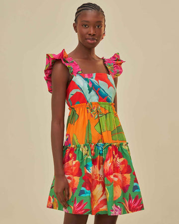 model wearing colorful floral midi dress with ruffle tank sleeves and mismatched floral tiers