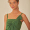 model wearing green cropped tank with oversized bow detail on the bust