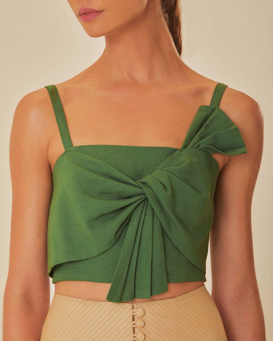 up close of model wearing green cropped tank with oversized bow detail on the bust