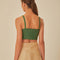 back view of model wearing green cropped tank with oversized bow detail on the bust