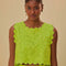 model wearing lime green cropped tank with scalloped edges and eyelet detail