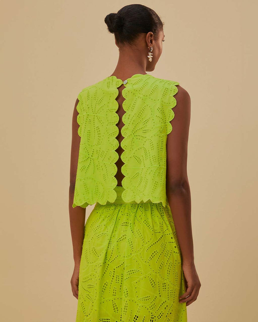 open back on model wearing lime green cropped tank with scalloped edges and eyelet detail