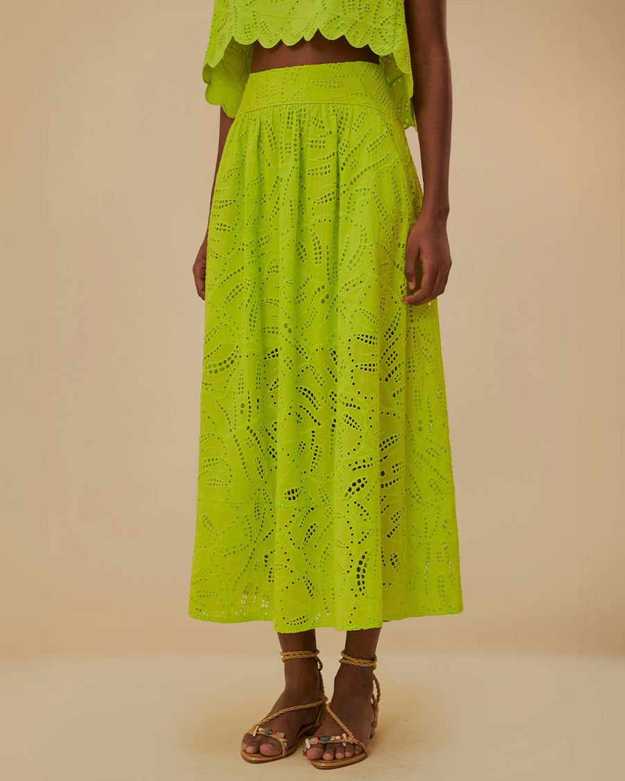model wearing lime green eyelet maxi skirt with pockets