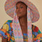 model wearing colorful fruit floppy beach hat with typography inside and long tie straps