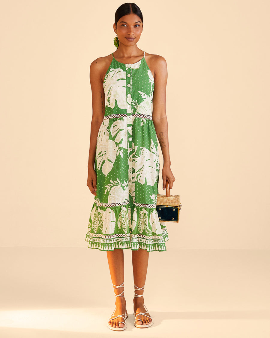 green midi dress with all over white dots, lace monstera design, ruffle hem and woven waistline