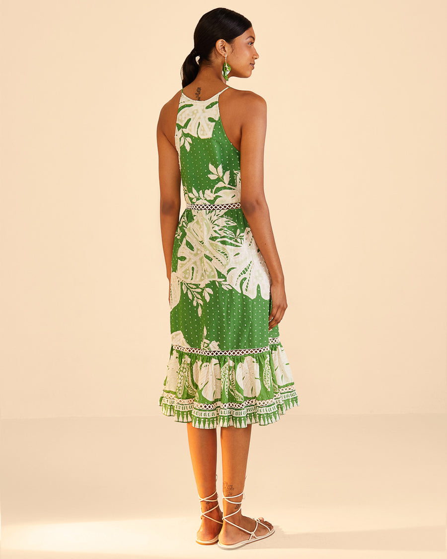 backview of green midi dress with all over white dots, lace monstera design, ruffle hem and woven waistline