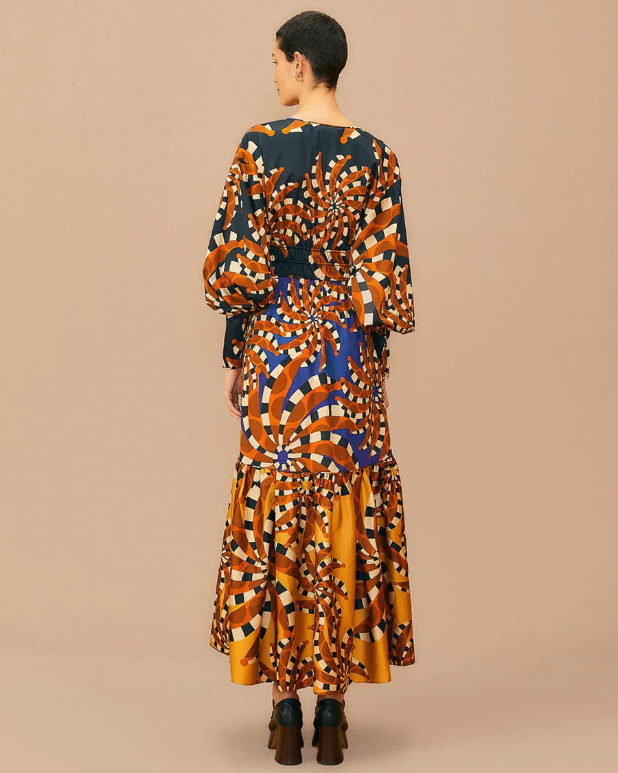 back view of model wearing colorful maxi dress with puff sleeves and deep V neckline