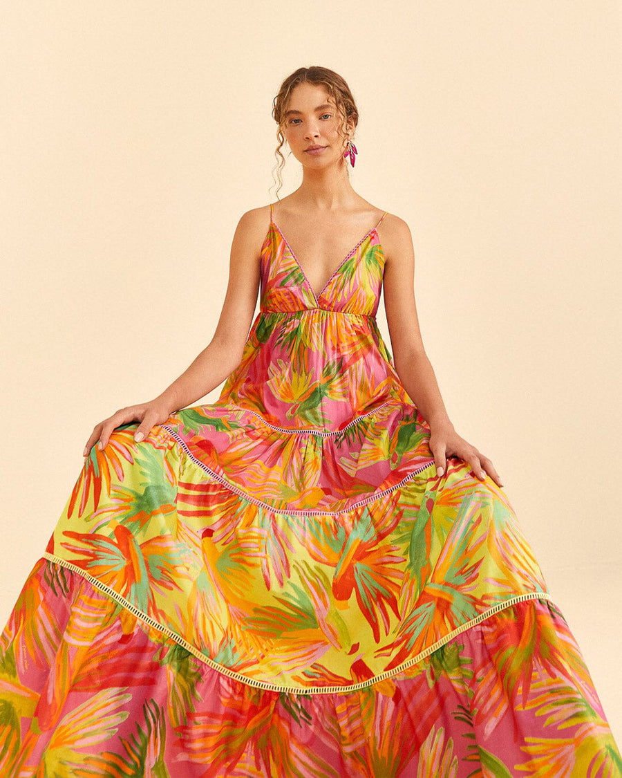 model wearing brightly colored painted birds maxi dress with ric rac tiers and scalloped v neckline