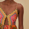 up close of model wearing colorful patchwork midi dress with button front and keyhole opening at the bust