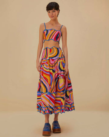 model wearing colorful midi skirt with wavy hems and periwinkle trim