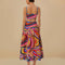 back view of model wearing colorful midi skirt with wavy hems and periwinkle trim