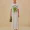 model wearing white tee shirt maxi dress with 'natureze' and palm tree print, short sleeves and tiered skirt