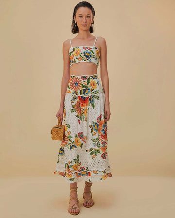model wearing white skirt with eyelet detail and colorful floral print