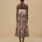 back view of model wearing white midi dress with colorful floral and fan print and tie straps