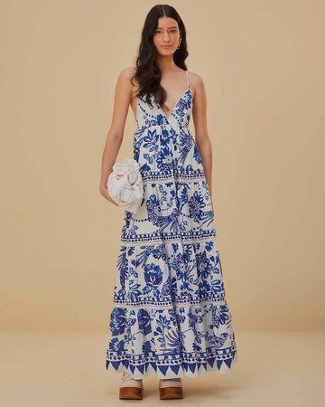 model wearing white and blue maxi dress with abstract birds and flower print